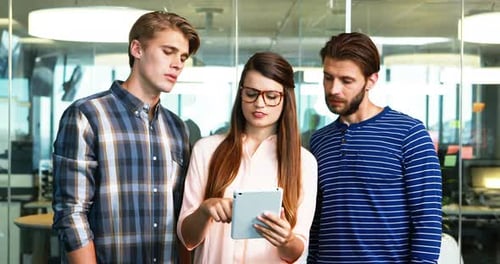 Executives discussing over digital tablet in office