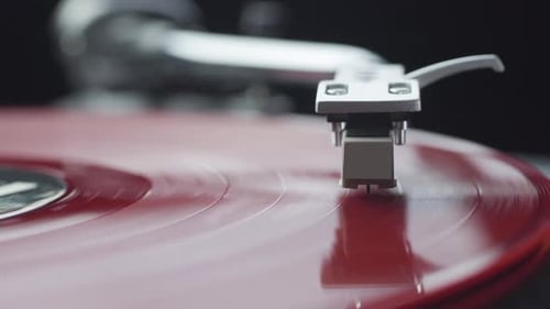 Focusing on Red Vinyl Record on the Turntable Player