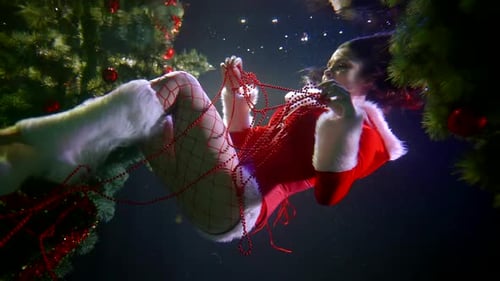 Underwater Christmas Fairy Tale, Woman in Erotic Suit of Santa Claus Is Floating in Pool