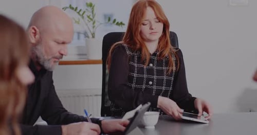 Businesswoman Using Tablet PC at Desk in Office