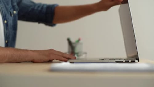Closeup Side View of Freelancer Man Opening Cover of Laptop and Starting Typing on Keyboard of