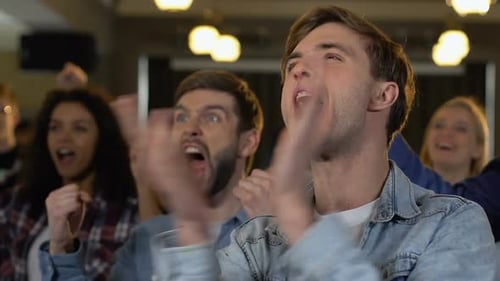Excited People Cheering Together at an Indoor Event