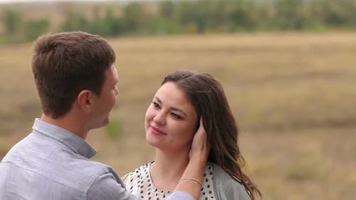 Closeup Portrait of a Couple in Love in a Field in Windy Weather