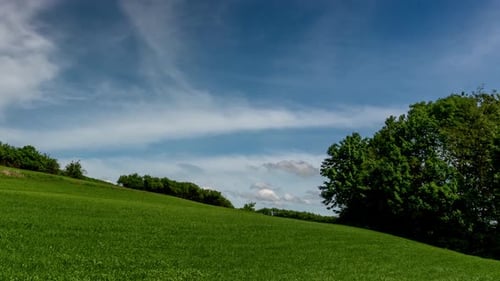 Rolling Green Hillside Landscape with Dynamic Sky