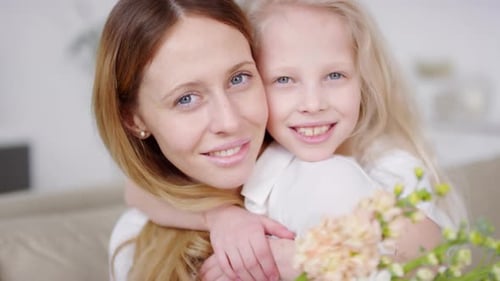 Mother and Daughter Smiling with Flowers Inside