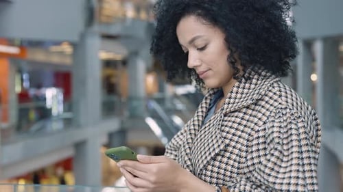 Woman with Smartphone in Urban Indoor Environment