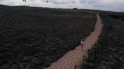 Girl Runs on Fine Sand Beach at Sunset