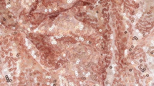 Tissu rose doré à paillettes