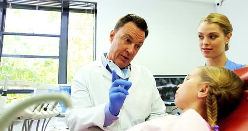 Dentist interacting with young patient