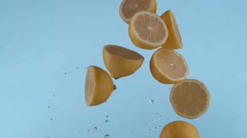 Juicy Lemon Halves Falling in Slow Motion