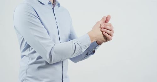 Person Rubbing Hands Together on White Background