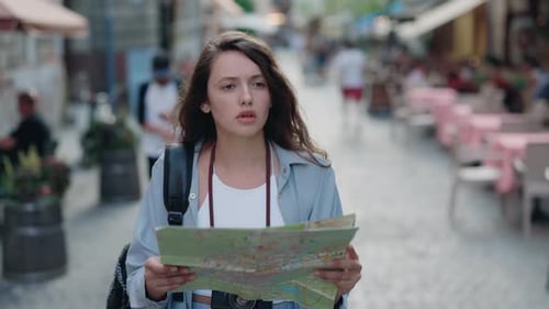Young Woman Exploring City with Map on Street