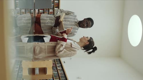 Multiethnic Library Visitors Discussing Book