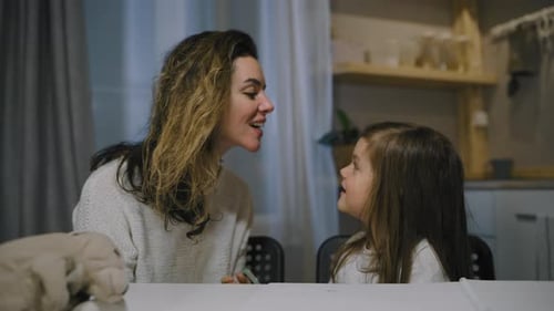 Loving Woman and Child Chatting at Home