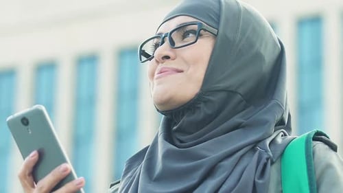 Happy Muslim Woman Reading Good News From Phone About Entering University
