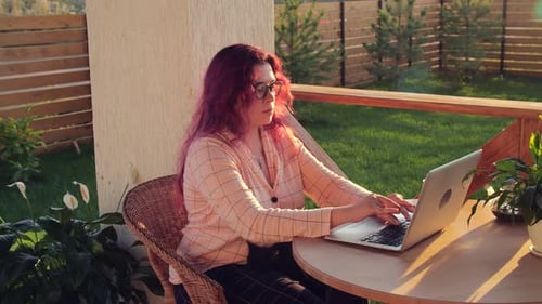 Woman Working on Laptop Outdoors