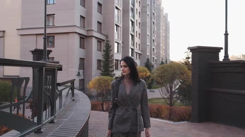 Attractive Girl of European Appearance Walks Down the Street Smiling