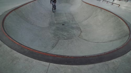 MTB Bicycle Rider Does Various Tricks While Riding in Skatepark