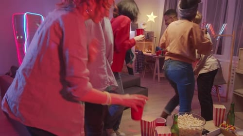 Company of Cheerful Friends Dancing Together at Home Party