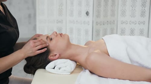 Woman Receives Relaxing Head Massage at Day Spa