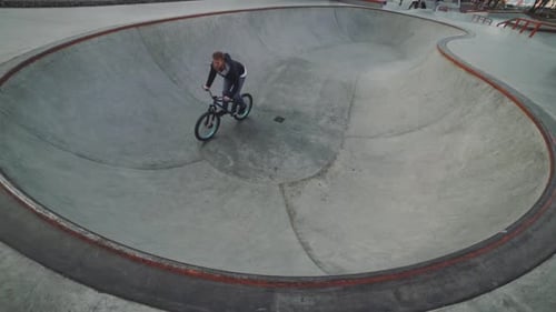 MTB Bicycle Rider Does Various Tricks While Riding in Skatepark