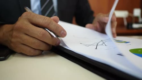 Businessman signing contract business documents.