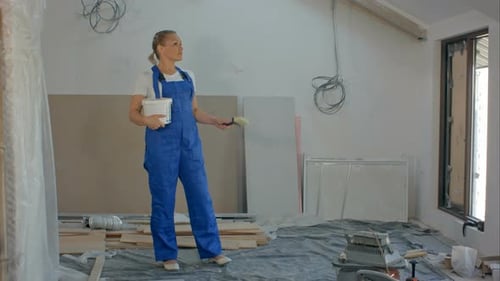 Woman With Paint in Unfinished Room