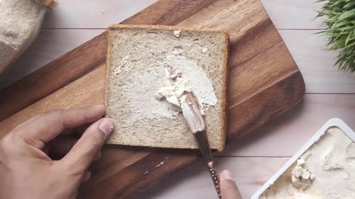 Spreading Cream Cheese on Bread