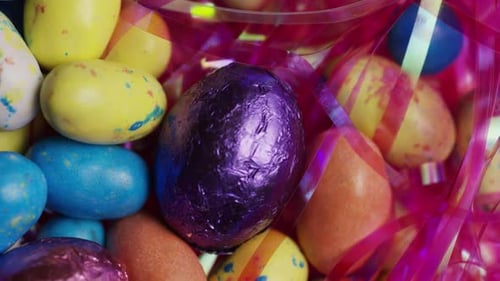 Rotating shot of colorful Easter candies on a bed of easter grass
