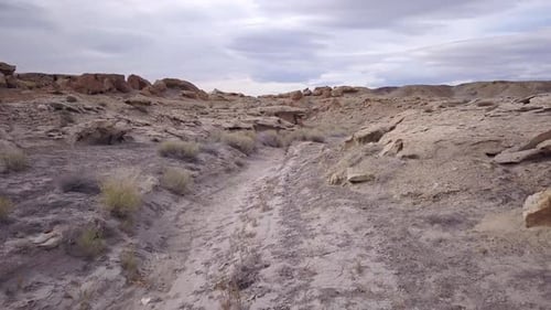Flying low through desert ravine over rocky terrain