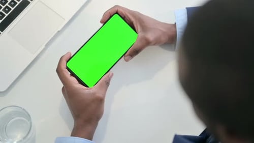Businessman Using Smartphone with Green Chroma Key Screen