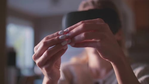 Person Wearing VR Headset Gesturing in Immersive Environment