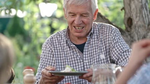 Family Sharing Food at Outdoor Meal