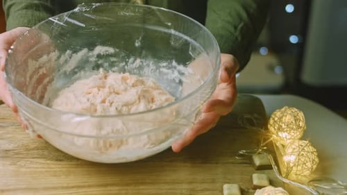 Woman Prepares Dough in Glass Bowl Indoors