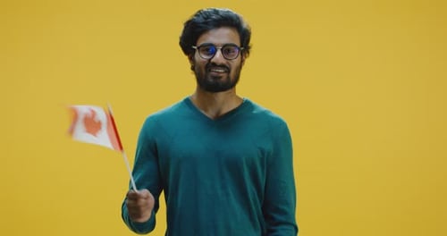 Young Man Waving a Canadian Flag