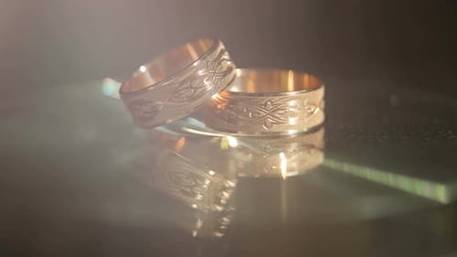 Close Up of Gold Wedding Rings on Glass