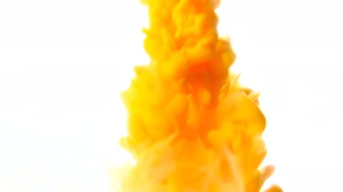 Yellow Ink Slowly Poured Into Water on a White Background