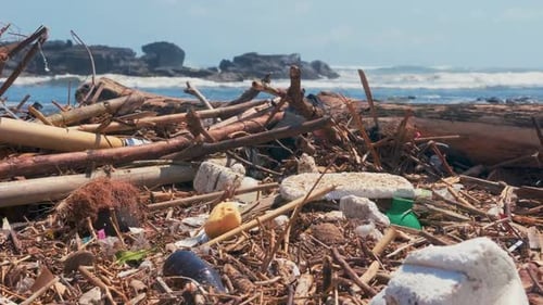 Plastic Bottles, Bags and Other Garbage Dumped on Dark Sand of Ocean Beach.