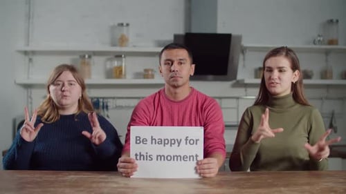 Adults Signing Message in Kitchen