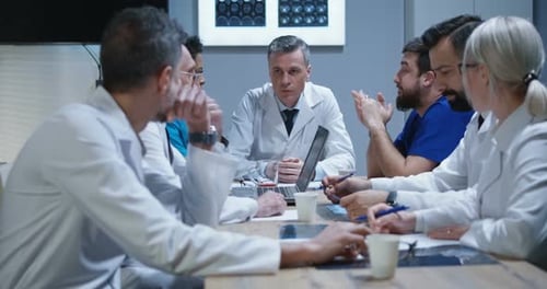 Medical Professionals Team Meeting in Hospital Room