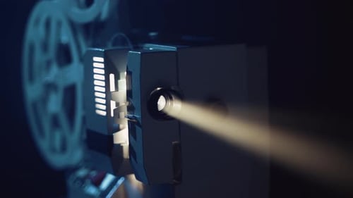 Vintage Film Projector Emitting Beam of Light in Dark