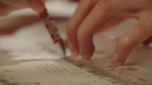 Nahaufnahme eines Zeichnungsdesignprojekts mit Lineal und rotem Stift