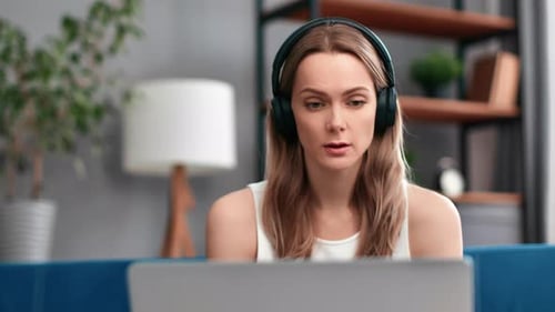 Woman Talking on Laptop with Headphones