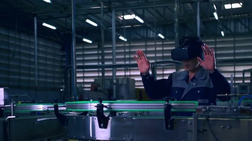 Engineer is using virtual reality glasses to inspect the factory's mechanical control sysEvt00101708
