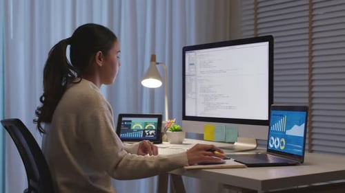 Asian woman data scientist work home night computer science program.