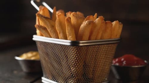Camera getting close to french fries. Slow Motion.
