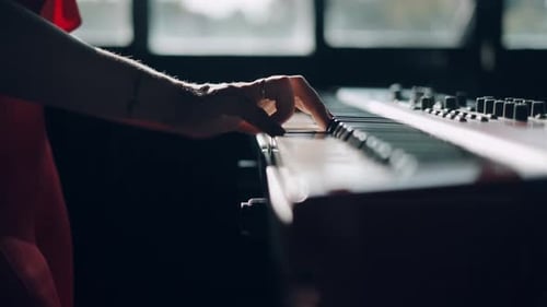 Hands Play Electronic Keyboard in Urban Setting