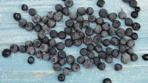 Fresh Blueberries Gradually Frosting on Wood Surface
