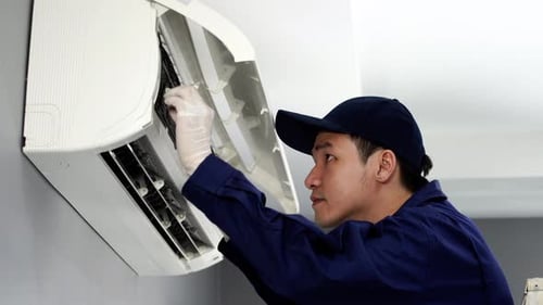 technician service removing air filter of the air conditioner for cleaning