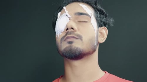 Applying White Creme Makeup to Face Close Up